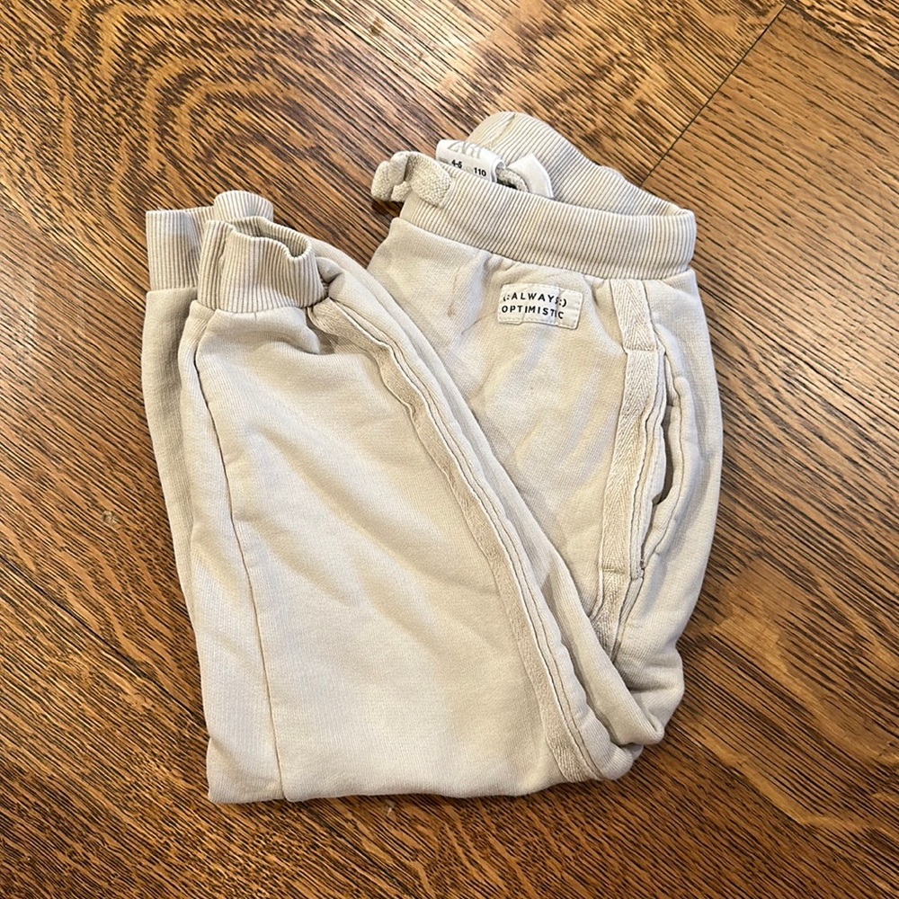 Zara kids nude colored sweatpants “Always Optimistic” patch at waistband.